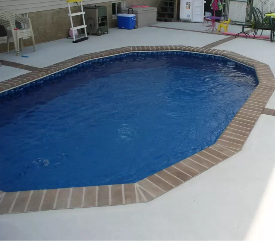 Aquasport 52 Pool Installed Fully In Ground With Brick Coping and Concrete Patio